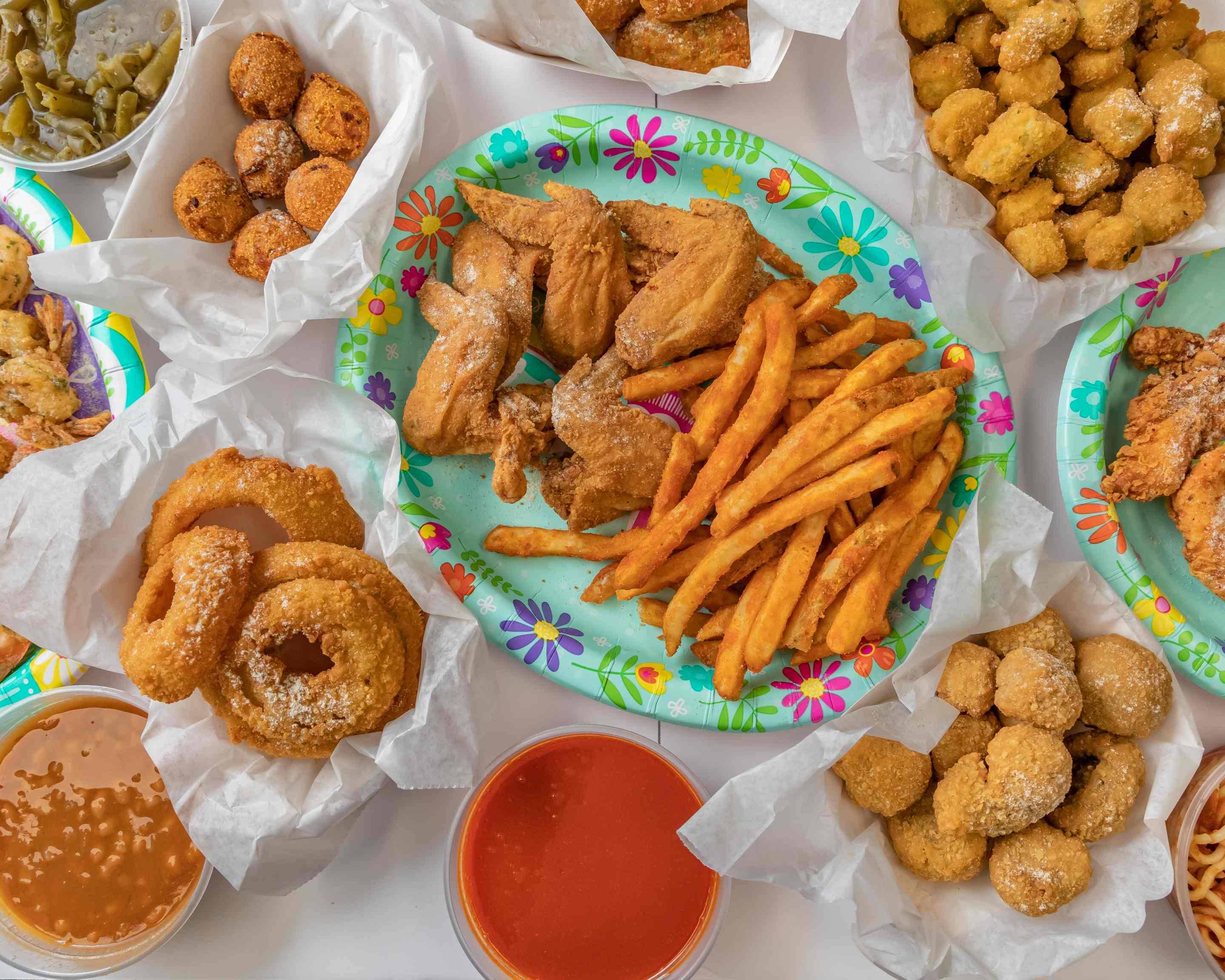 Soul food spread with fried chicken wings, fries, hush puppies, fried okra, onion rings from J's Fish and Chicken
